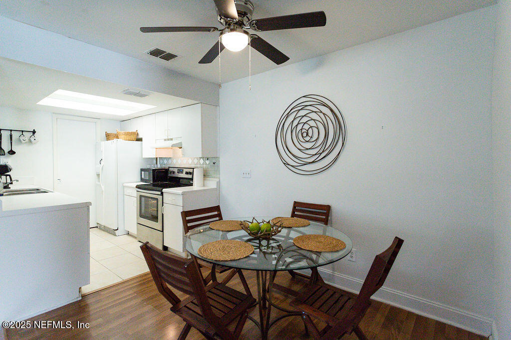 5328 Arlington Road Jacksonville, FL 32211 - Photo 6 of 16 a view of a dining room with furniture and a clock
