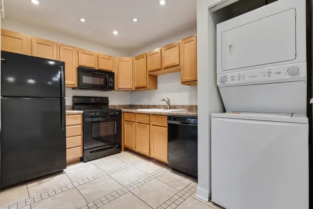 a kitchen with a sink and steel appliances