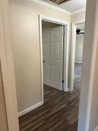 a view of a hallway with wooden floor