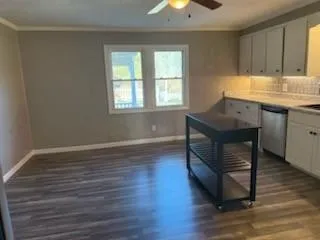 a room with wooden floors and window