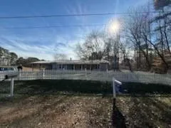 a view of a house with yard and sitting area
