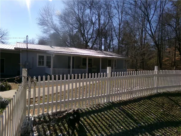 a view of a house with a wooden fence