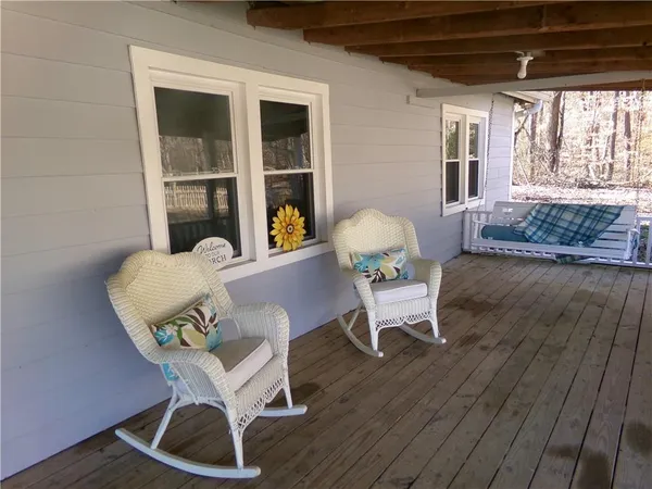 a living room filled with furniture and a potted plant