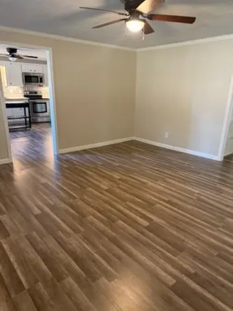 a view of empty room with wooden floor
