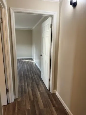 a view of an empty room with wooden floor