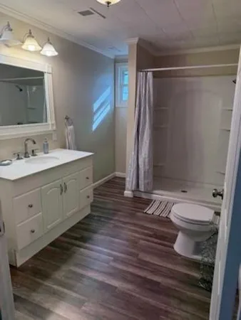 a bathroom with a double vanity sink toilet and shower