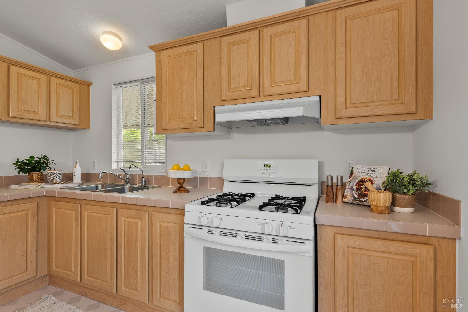 5754 Lois Avenue Santa Rosa, CA 95403 - Photo 11 of 23 a kitchen with stainless steel appliances granite countertop a sink stove and cabinets