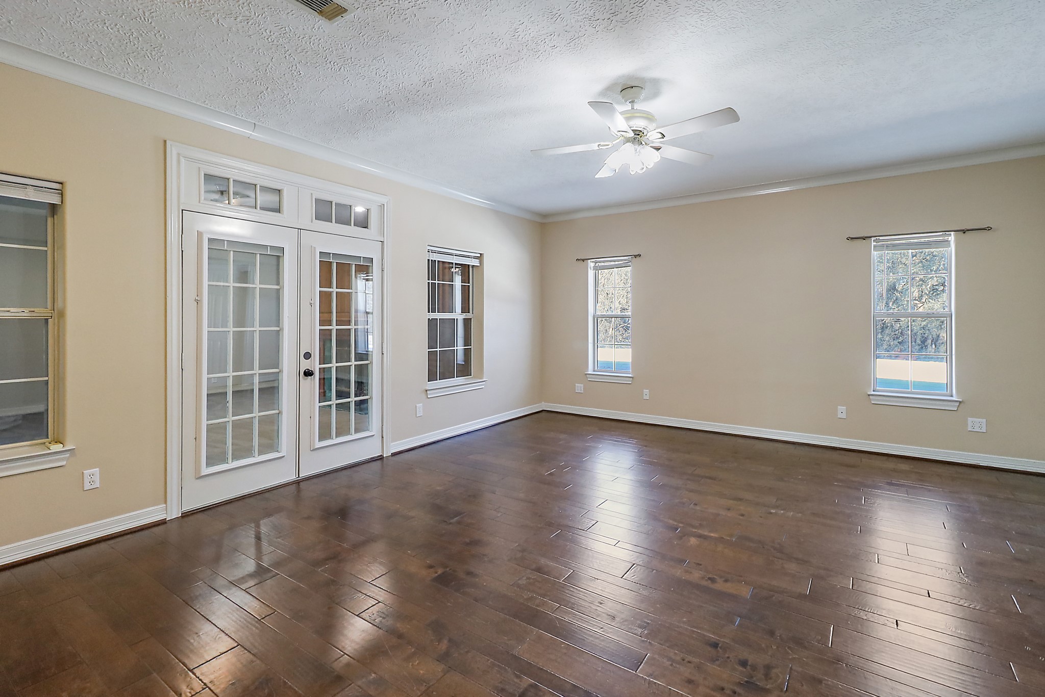 1306 Spring Branch Drive Baytown, TX 77523 - Photo 20 of 38 a view of an empty room with wooden floor and a window