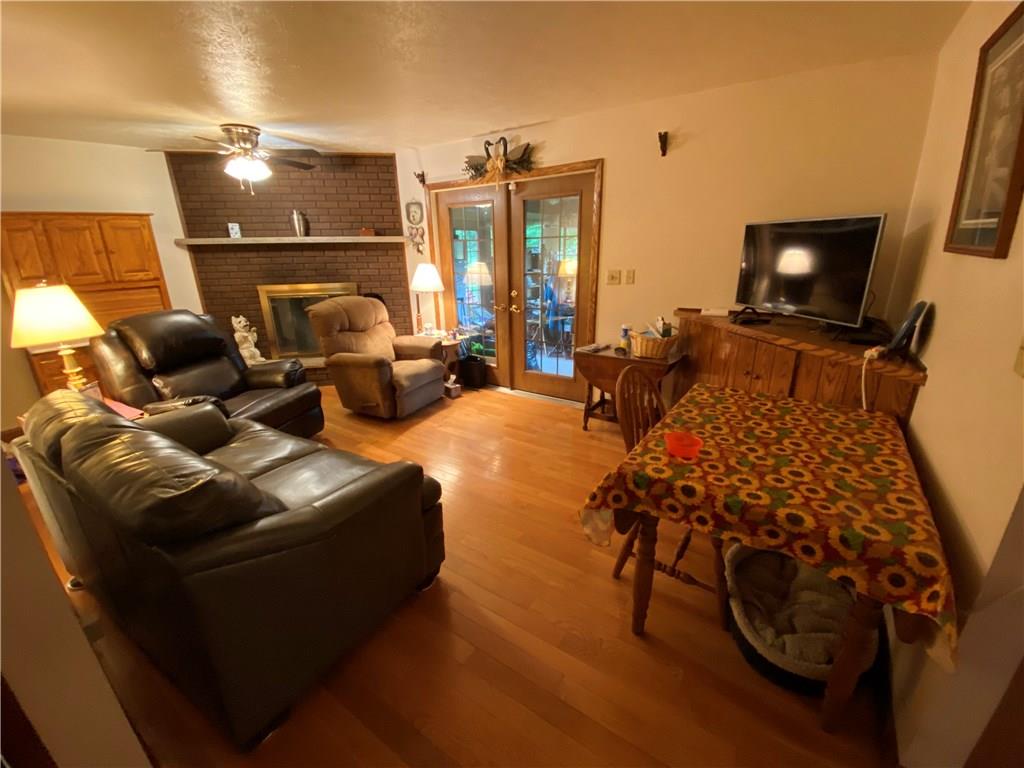 97 Gibson Road Greenville, PA 16125 - Photo 18 of 23 Family room has fireplace, hardwood floors.