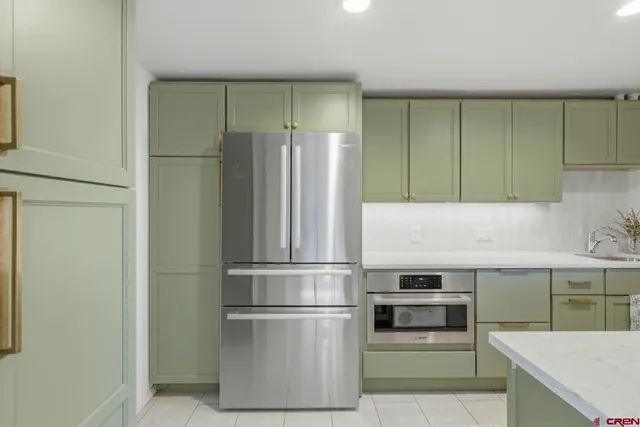 a kitchen with cabinets and stainless steel appliances
