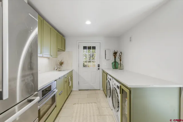 a kitchen with a sink and refrigerator
