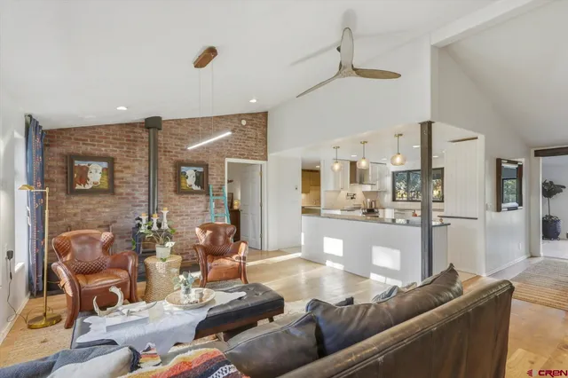 a living room with furniture and kitchen view