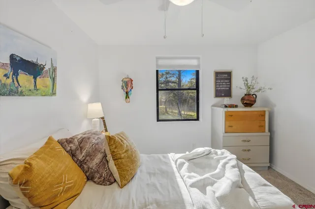 a bedroom with a bed and cupboard