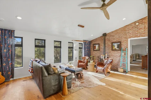 a living room with furniture and large window