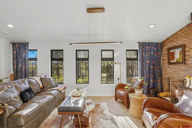 a living room with furniture and large windows