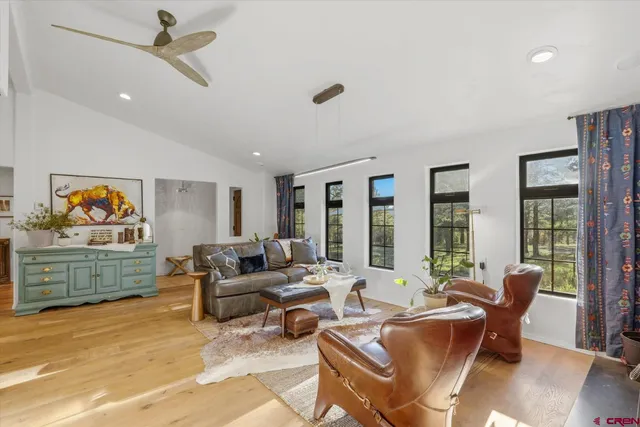 a living room with furniture and large window