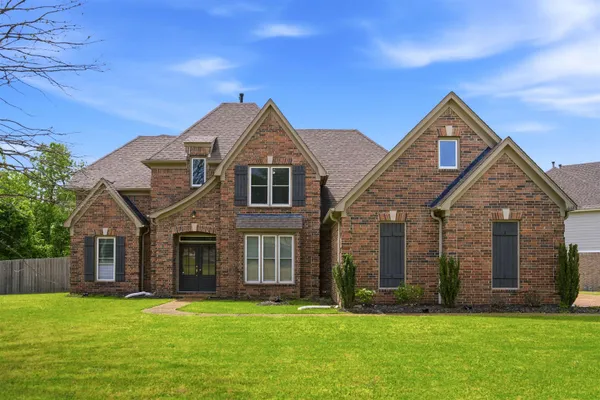 a front view of a house with a yard