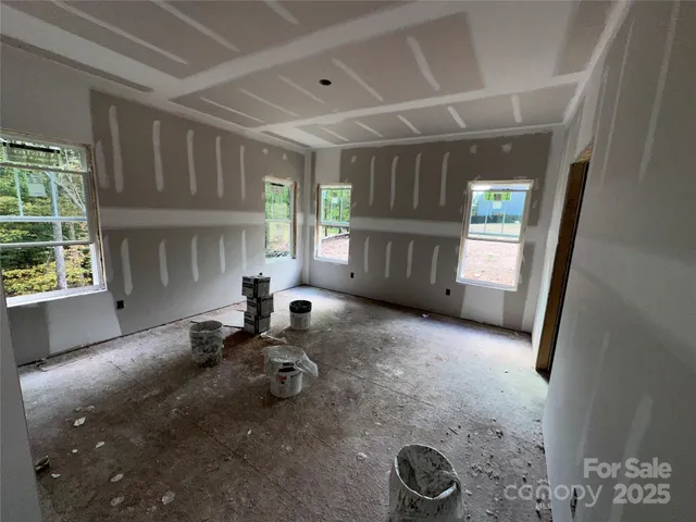 a view of a hallway with entryway and chandelier