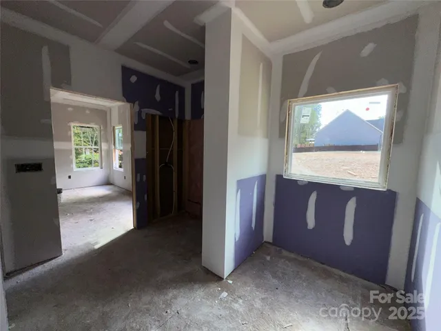 a view of hallway with a door and a rug