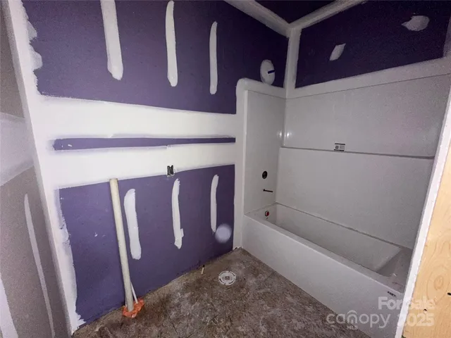 a bathroom with bathtub and shower