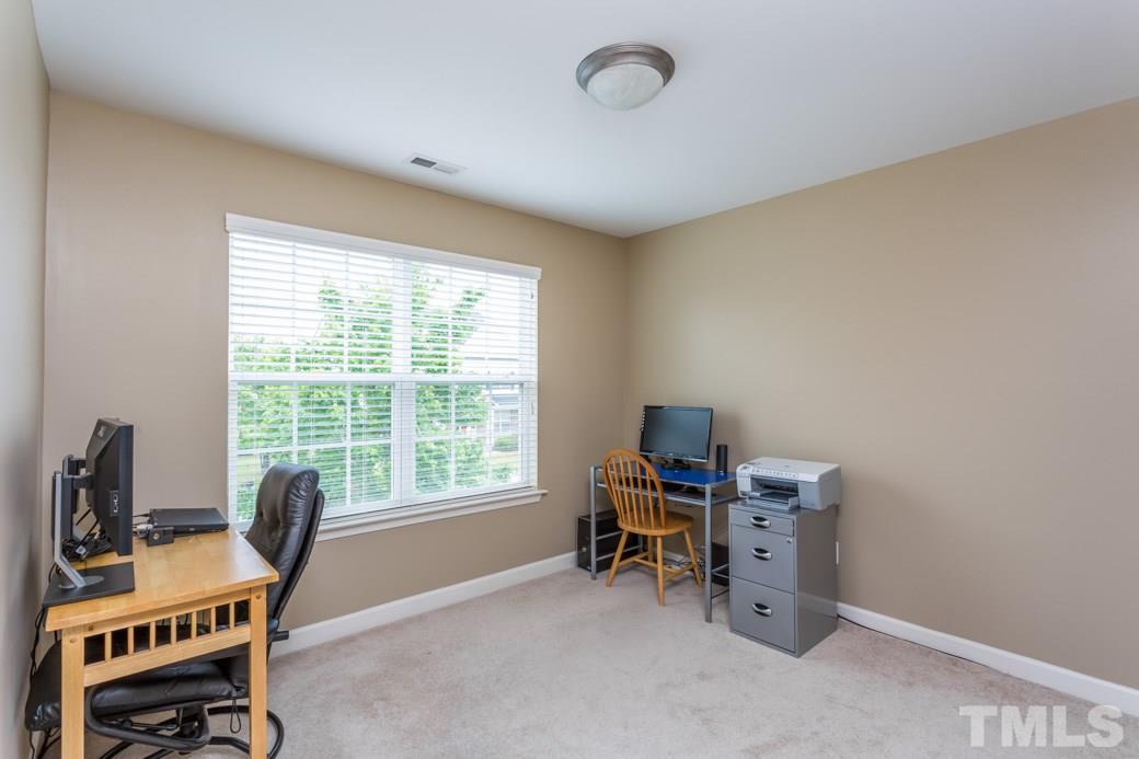 5332 Glass Ridge Road Raleigh, NC 27616 - Photo 13 of 18 a view of a workspace with furniture and a window