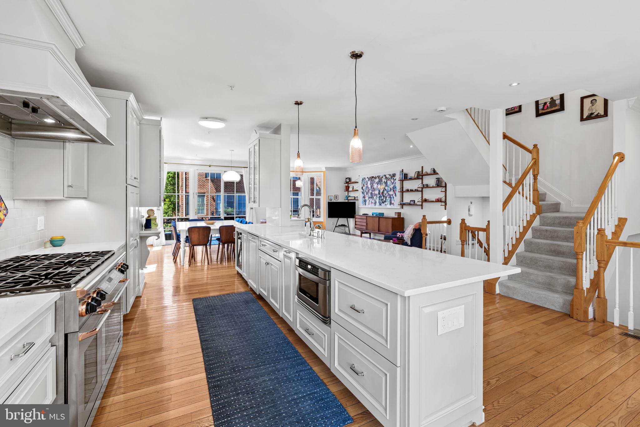 2331 Boston Street, Unit 1 Baltimore, MD 21224 - Photo 24 of 74 a large kitchen with stainless steel appliances granite countertop a stove and wooden floor