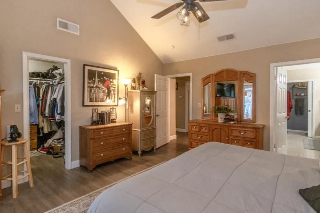 a bedroom with a bed and a large mirror