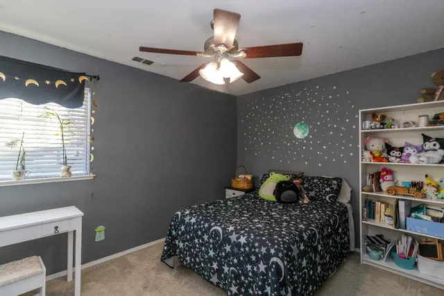 a bedroom with a bed and window