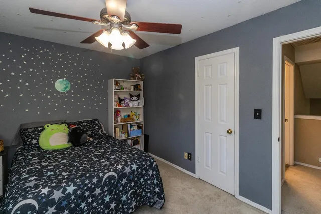 a bedroom with a bed and a chandelier
