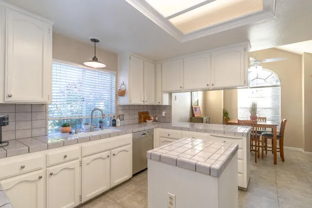 a kitchen with a stove a sink a refrigerator and cabinets