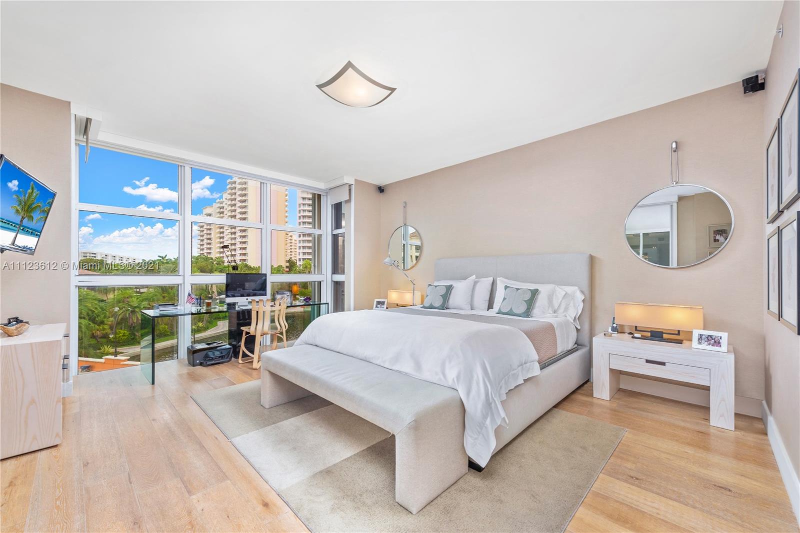 739 Crandon Boulevard, Unit PH1 Key Biscayne, FL 33149 - Photo 16 of 33 a spacious bedroom with a large bed and a large window