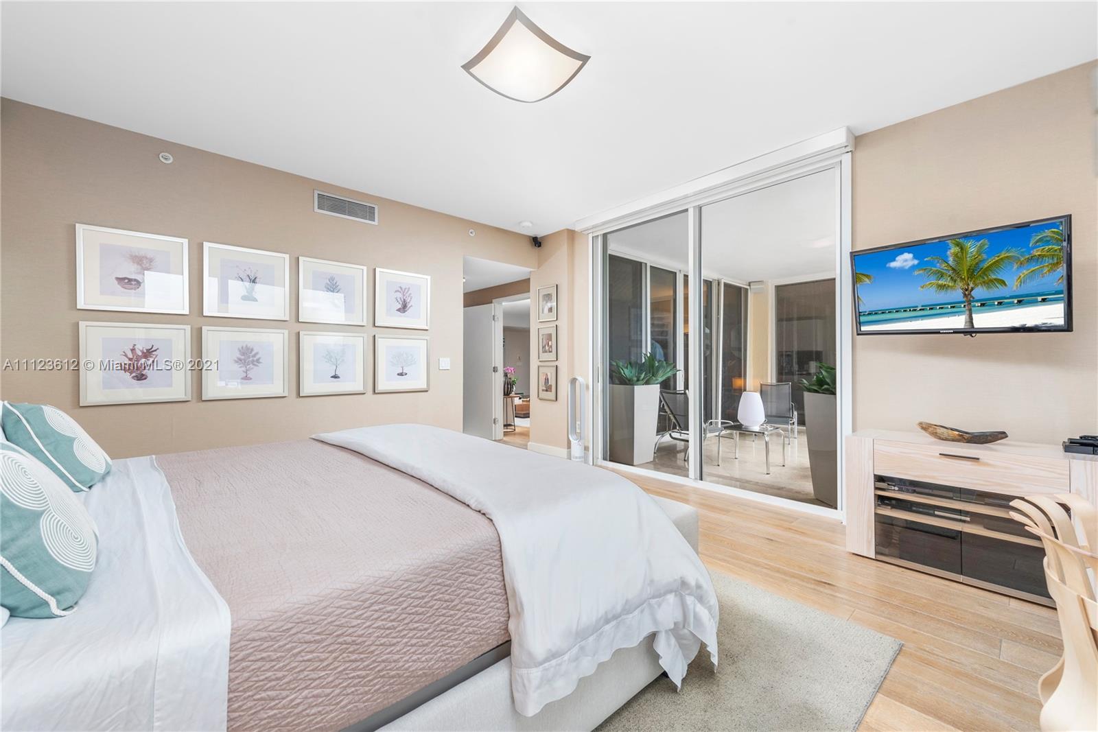 739 Crandon Boulevard, Unit PH1 Key Biscayne, FL 33149 - Photo 18 of 33 a bedroom with a large bed and a window