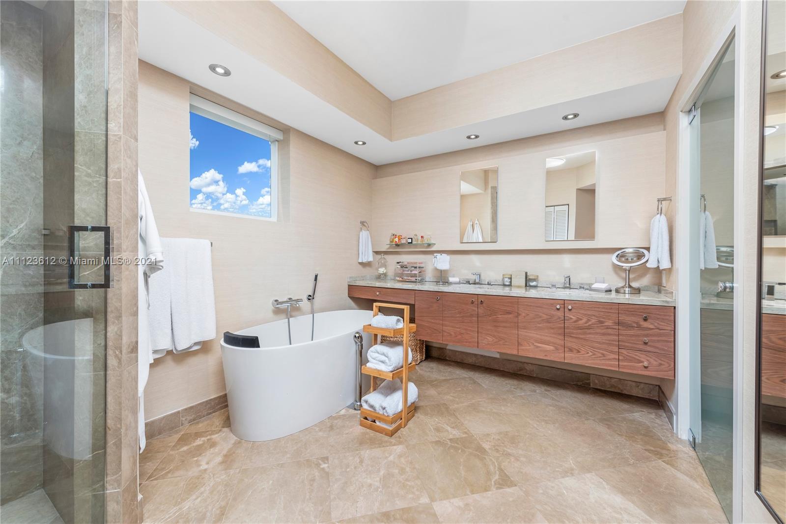 739 Crandon Boulevard, Unit PH1 Key Biscayne, FL 33149 - Photo 19 of 33 a bathroom with a tub sink and mirror