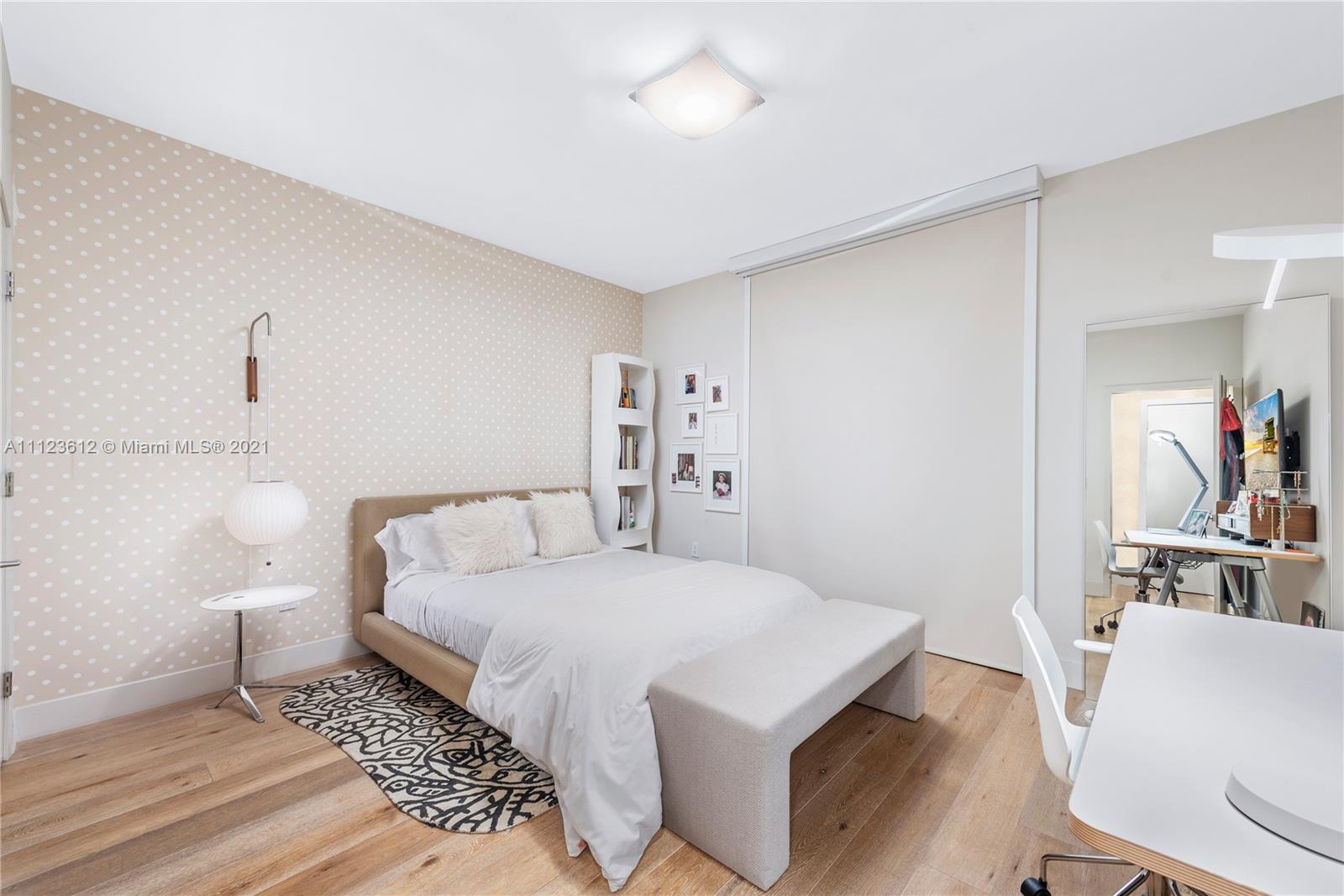 739 Crandon Boulevard, Unit PH1 Key Biscayne, FL 33149 - Photo 21 of 33 a bedroom with a bed and a chair