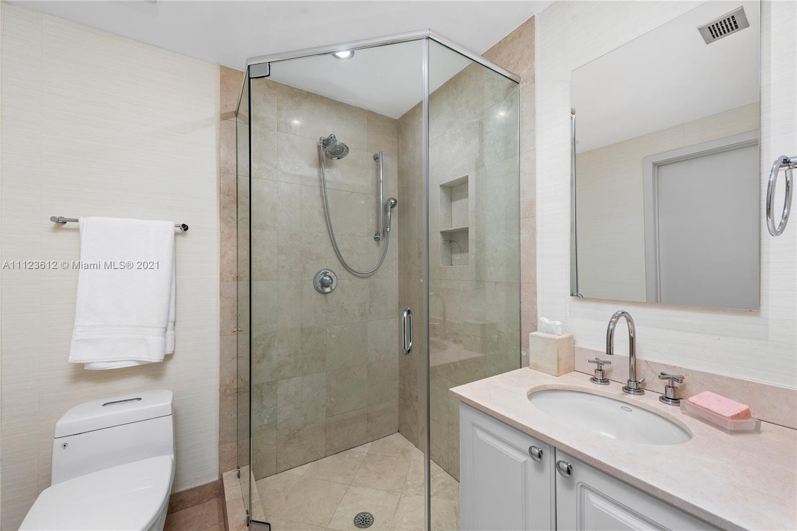 739 Crandon Boulevard, Unit PH1 Key Biscayne, FL 33149 - Photo 23 of 33 a bathroom with a shower sink vanity mirror and toilet