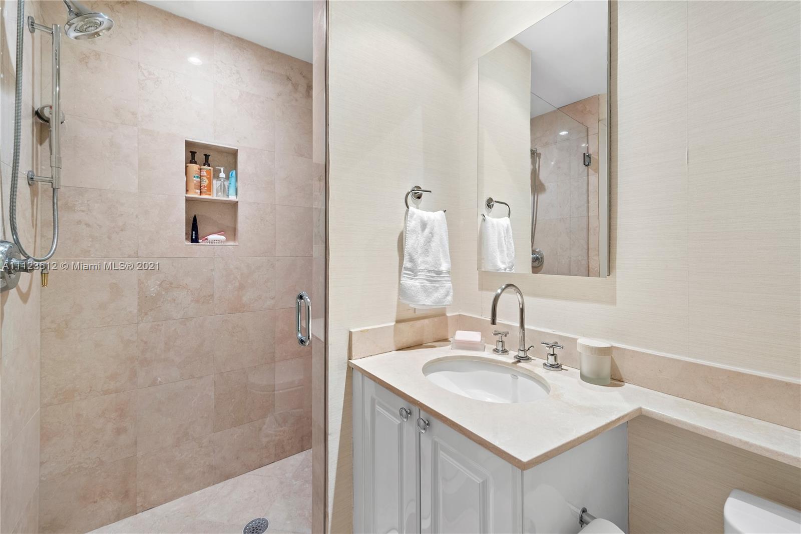 739 Crandon Boulevard, Unit PH1 Key Biscayne, FL 33149 - Photo 26 of 33 a bathroom with a sink and a mirror