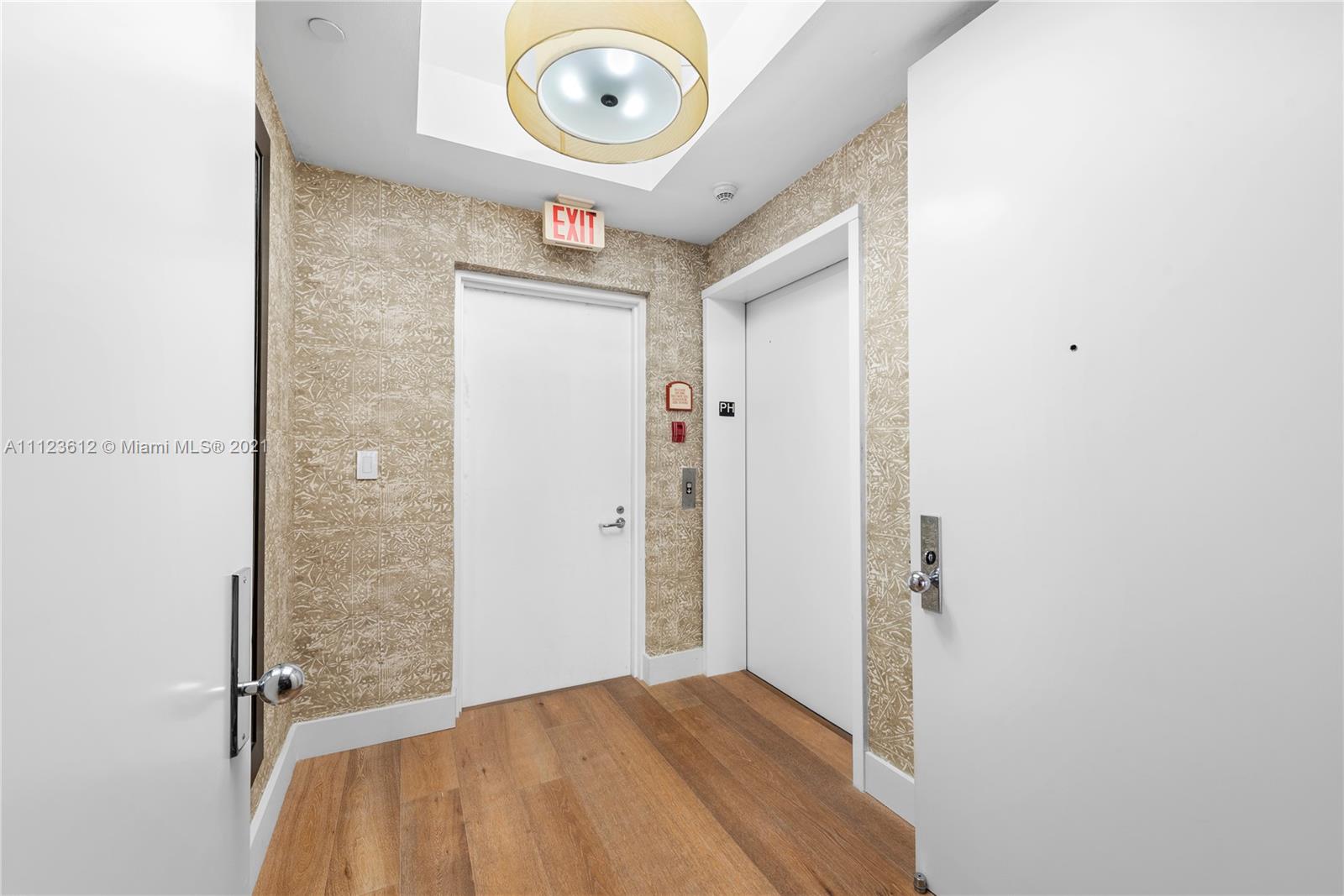 739 Crandon Boulevard, Unit PH1 Key Biscayne, FL 33149 - Photo 27 of 33 a view of a hallway to a room