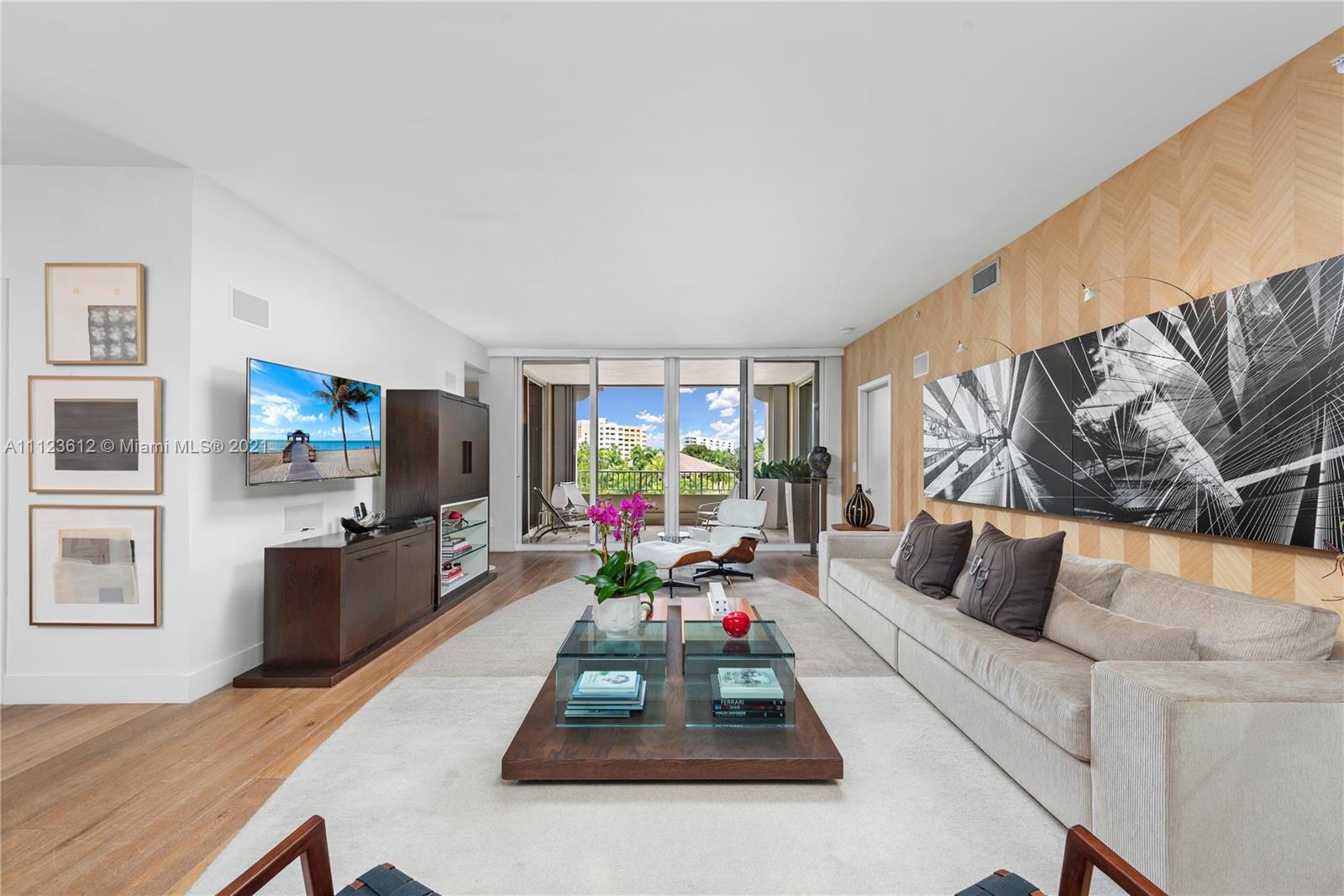 739 Crandon Boulevard, Unit PH1 Key Biscayne, FL 33149 - Photo 6 of 33 a living room with furniture flat screen tv and a large window