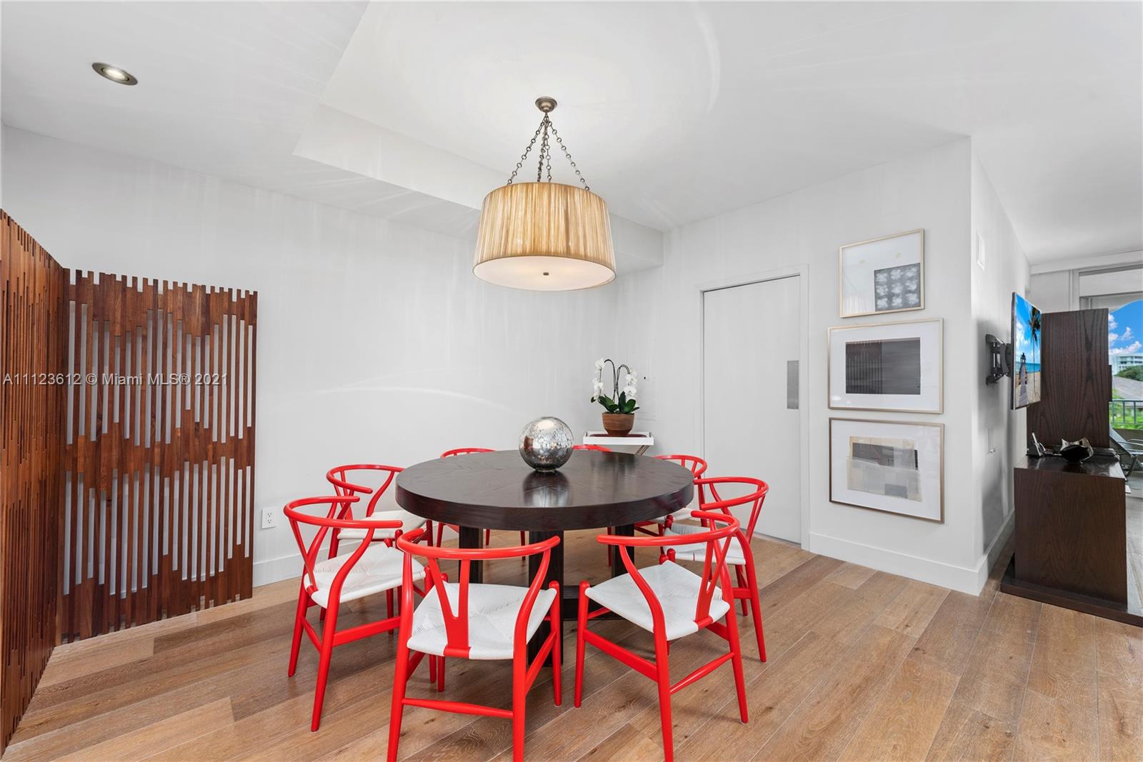 739 Crandon Boulevard, Unit PH1 Key Biscayne, FL 33149 - Photo 10 of 33 a dining room with furniture a chandelier and wooden floor