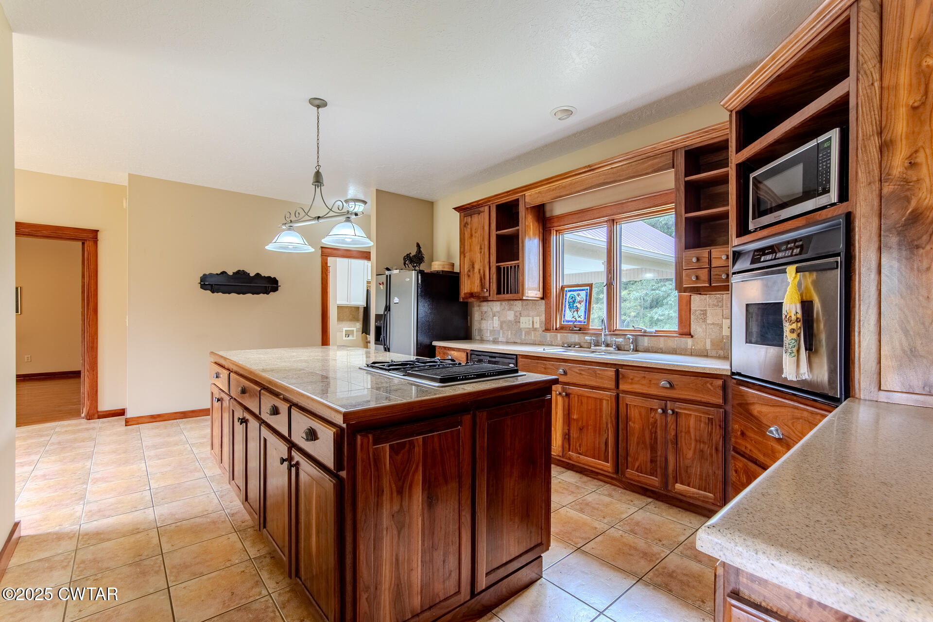 3554 Shades Bridge Road Greenfield, TN 38230 - Photo 13 of 49 a kitchen with stainless steel appliances granite countertop a stove a sink dishwasher and a refrigerator with wooden floor