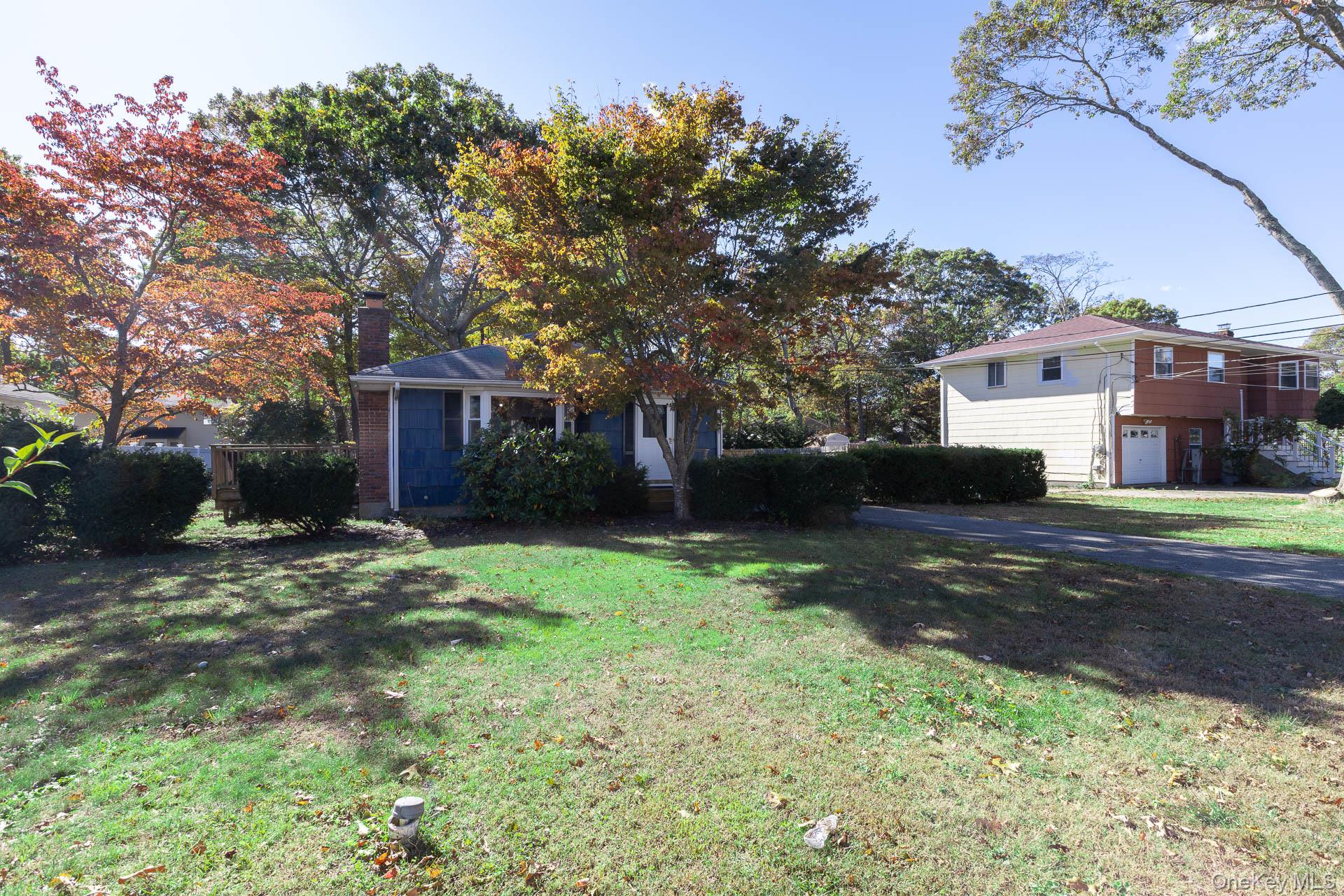 View of front of home with a chimney and a front yard