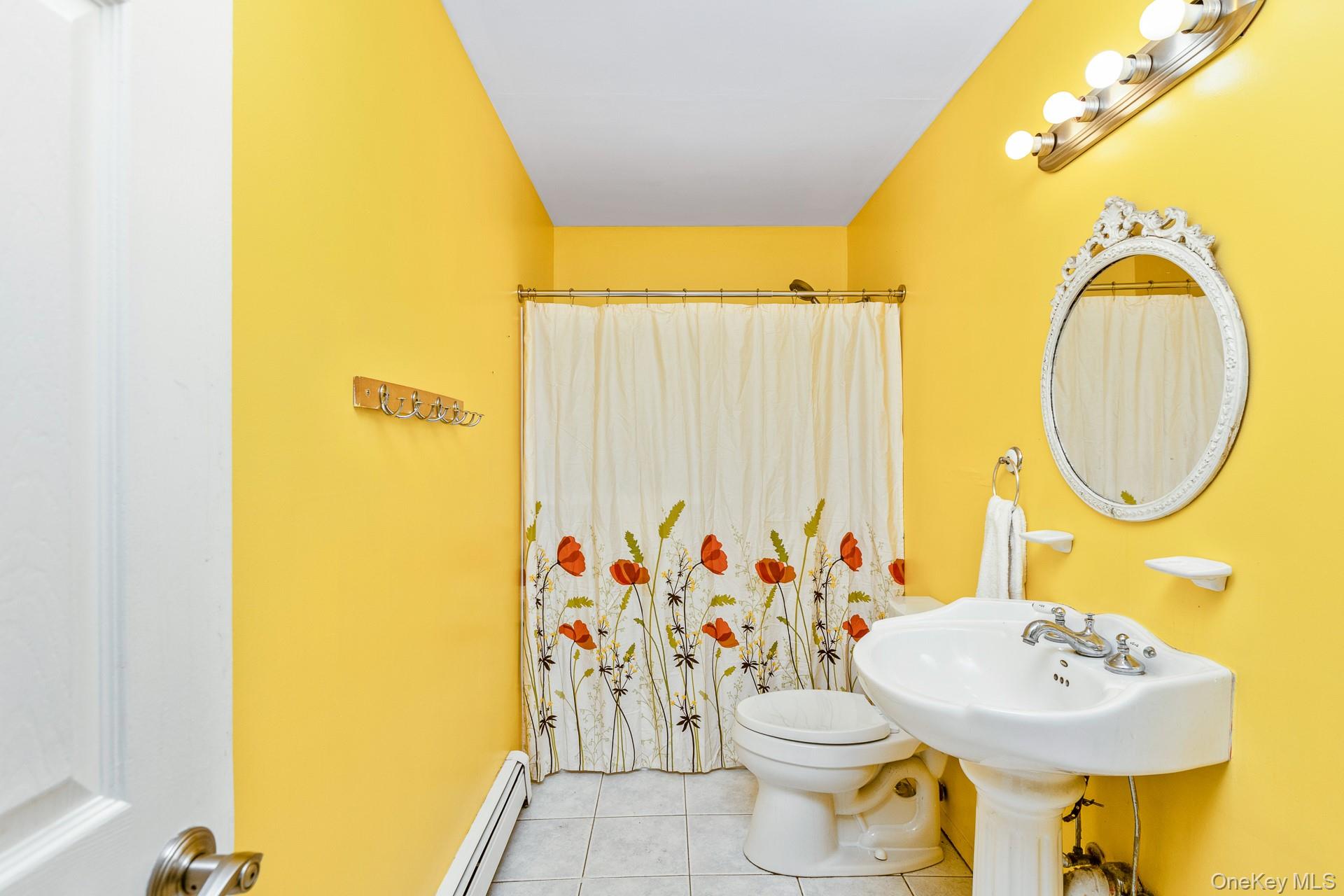 12 Applegate Drive Mastic, NY 11950 - Photo 15 of 29 Full bathroom featuring tile patterned floors, a baseboard radiator, and a shower with curtain