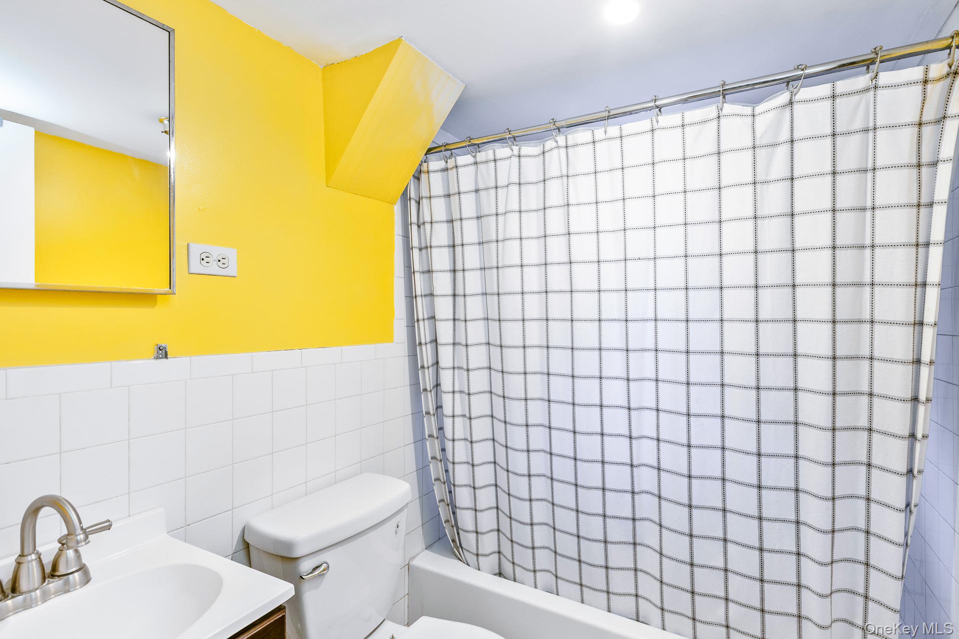 12 Applegate Drive Mastic, NY 11950 - Photo 21 of 29 Bathroom featuring tile walls, vanity, and shower / bath combo