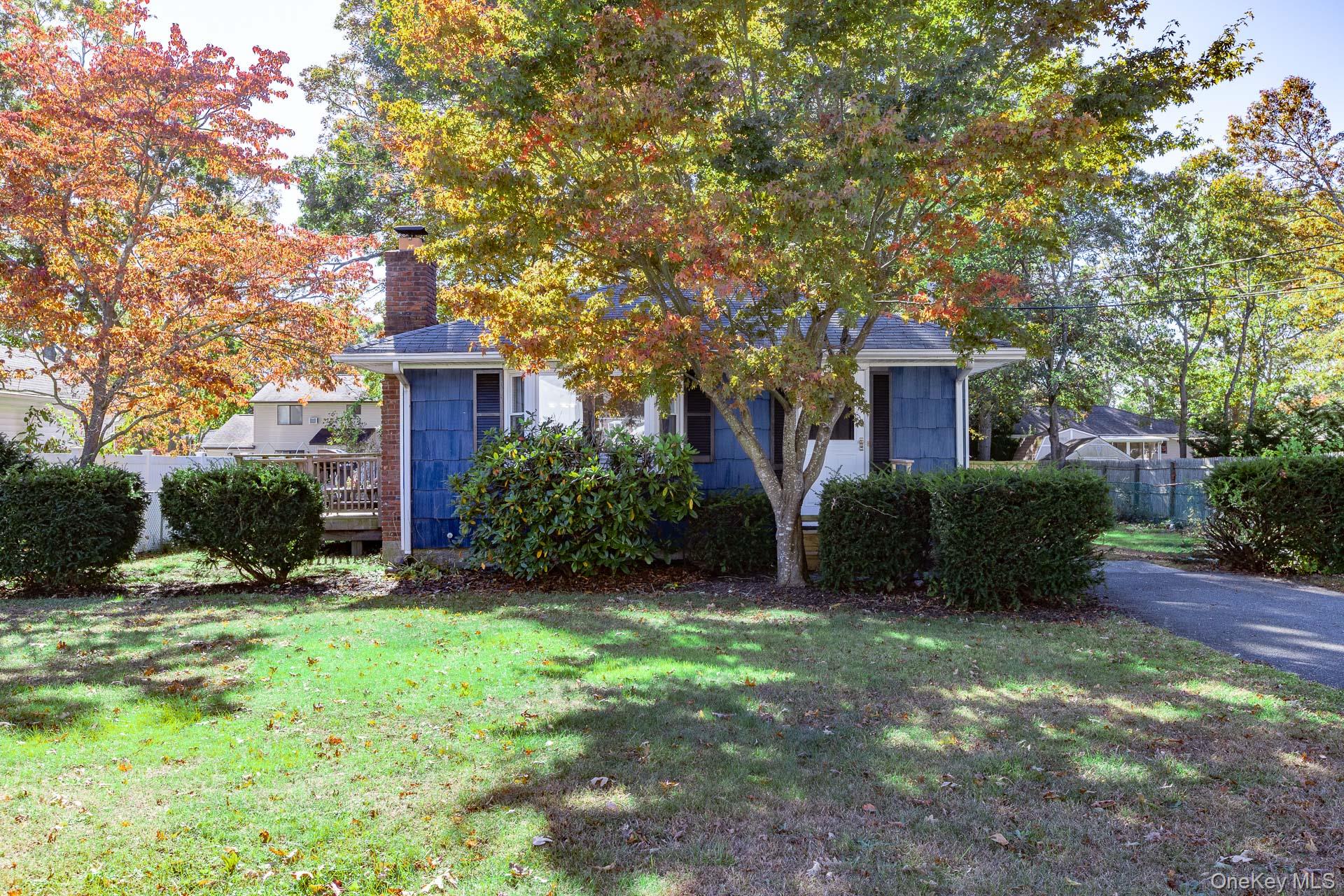 12 Applegate Drive Mastic, NY 11950 - Photo 3 of 29 View of property hidden behind natural elements featuring a chimney