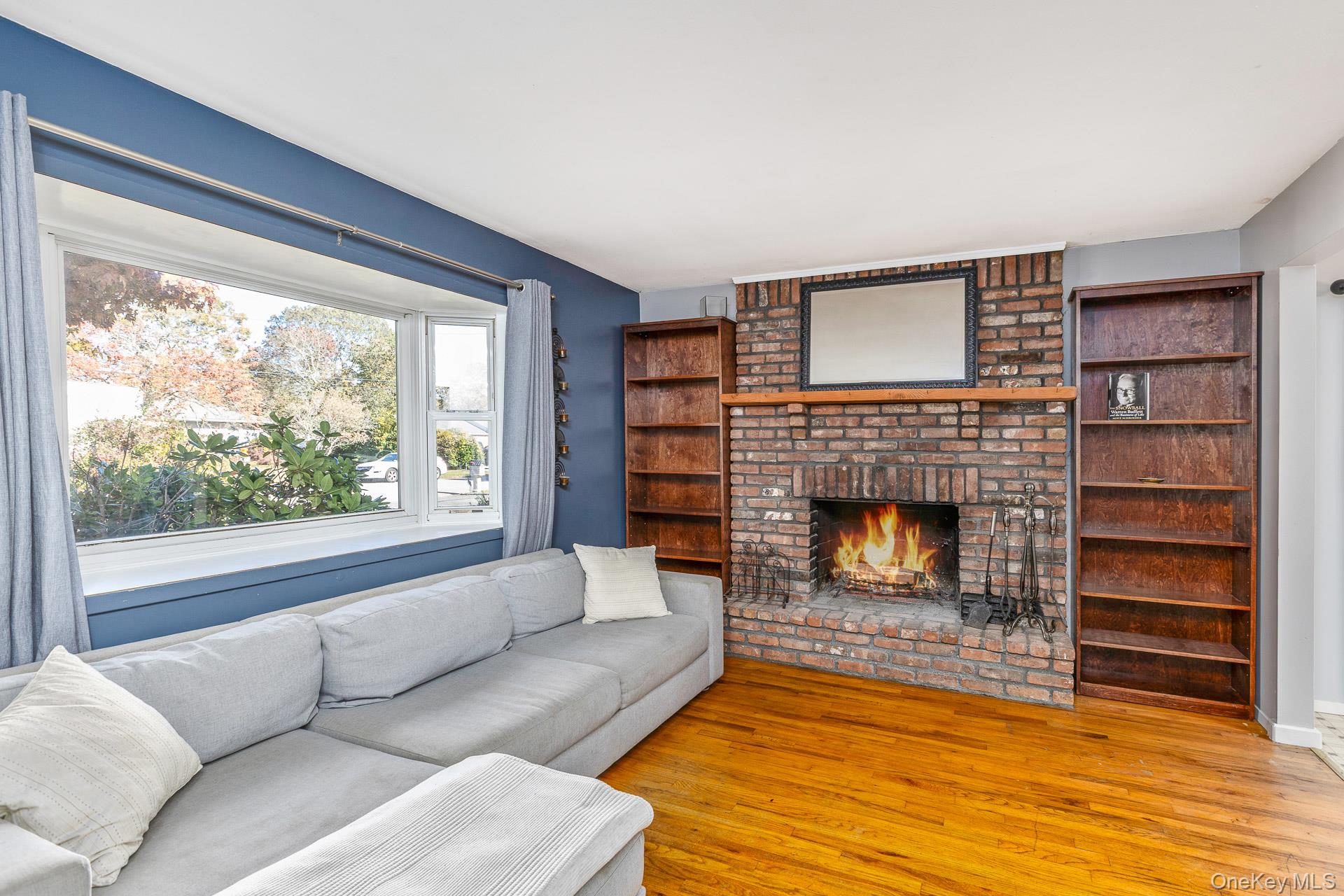 12 Applegate Drive Mastic, NY 11950 - Photo 6 of 29 Living room featuring wood finished floors and a fireplace