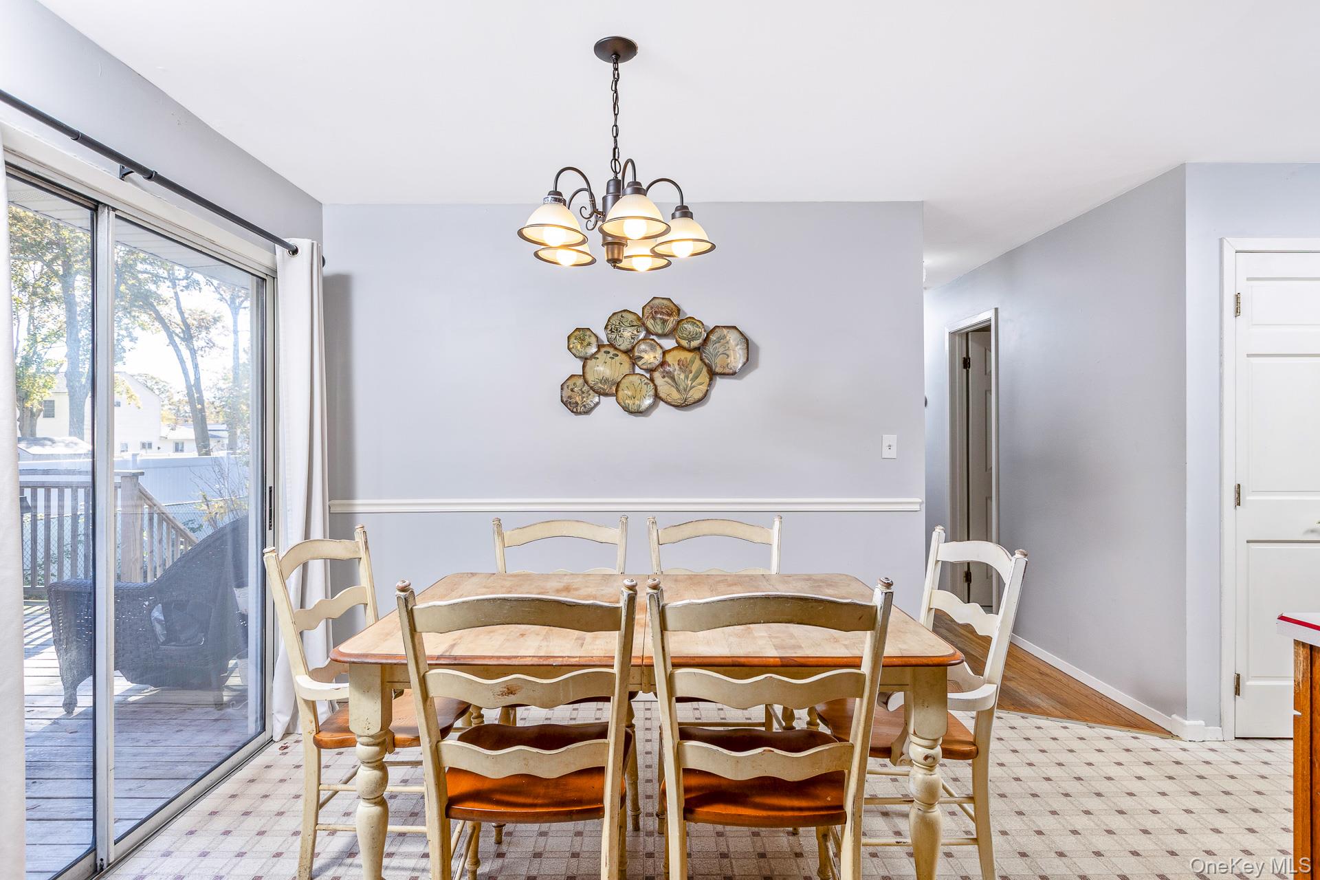 12 Applegate Drive Mastic, NY 11950 - Photo 9 of 29 Dining room featuring a chandelier and light wood-type flooring