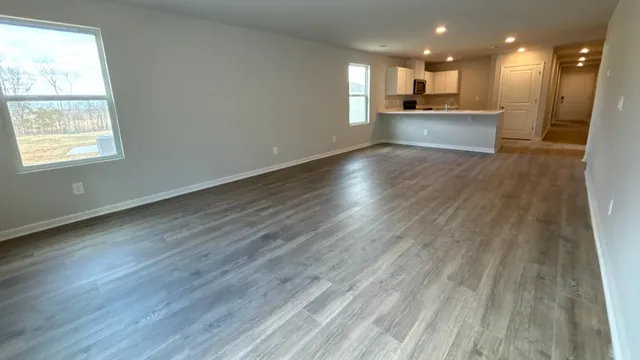 a view of kitchen with kitchen island granite countertop cabinets and wooden floor