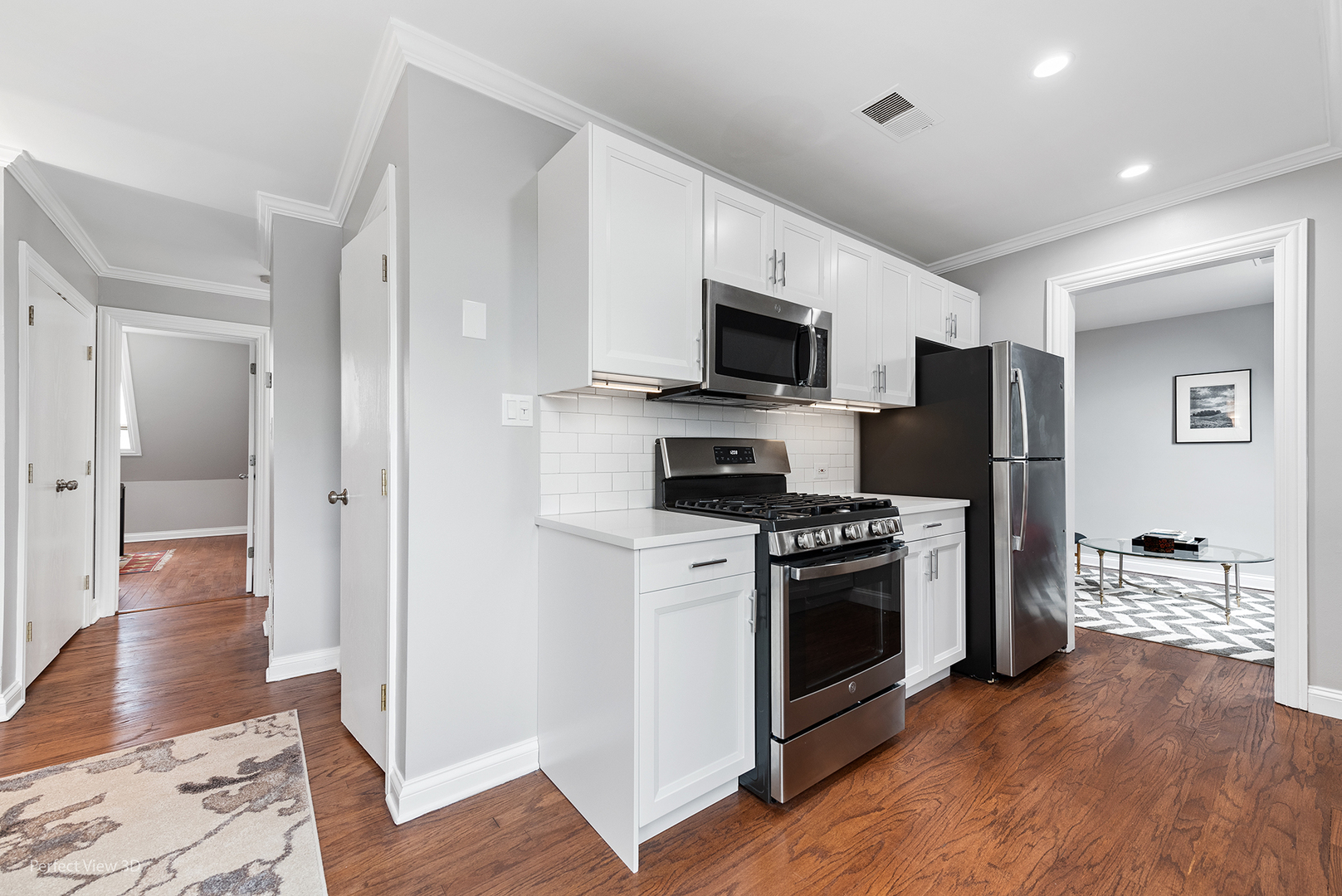 4938 South Drexel Boulevard, Unit 310 Chicago, IL 60615 - Photo 10 of 20 a kitchen with a refrigerator stove and wooden floor