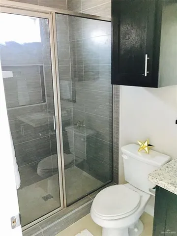 a white toilet sitting next to a bathroom