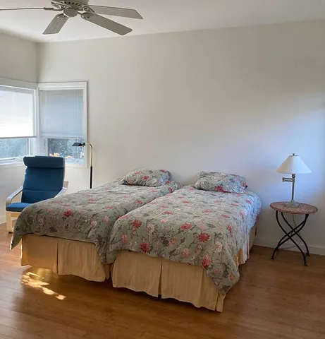 a bedroom with two beds and painting on the wall